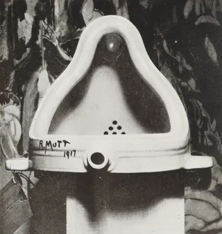 A porcelain urinal positioned upright, photographed in black and white.